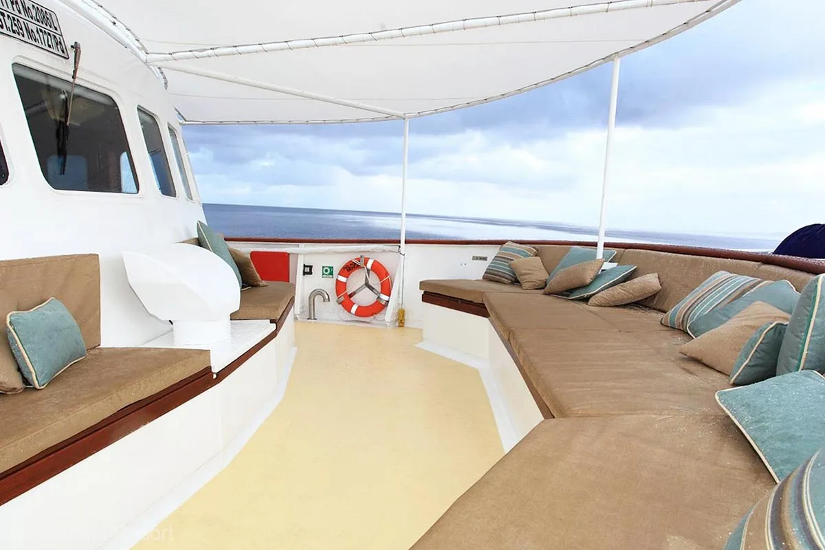 A shaded sitting area with a lifebuoy in between. Pelagian. Pelagian Dive Yacht. Wakatobi diving. Pelagian Liveaboard. Wakatobi Resort. Wakatobi. Wakatobi National Park. Luxury liveaboard Indonesia. Luxury liveaboard Wakatobi. Diving expeditions Indonesia.Reef diving Indonesia. Indonesia Liveaboard trip. Yacht charter Indonesia. Boat rental Indonesia. Diving trip in Indonesia. Luxury diving trip. Bespoke Indonesia Holiday.